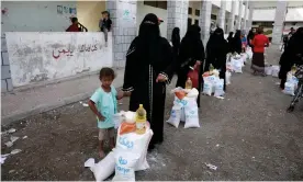  ??  ?? Yeminis collecting their family’s aid rations in the port city of al-Hudaydah. The UN is warning that the cost of food is likely to rise by as much as 400%. Photograph: Yahya Arhab/