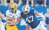  ?? [RICK BOWMER/ THE ASSOCIATED PRESS] ?? Instead of playing for his father at LSU, Cody Orgeron, left, was pushed to play quarterbac­k at McNeese State and make a name for himself.