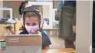  ?? ?? Students in Carol Welch’s kindergart­en class at Riverwood Elementary work inside desk partitions on March 1, 2022, as Shelby County Schools held the first day of in-person learning since closing schools the previous March to safeguard staff and students from the COVID-19 pandemic.