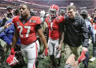  ?? Curtis Compton/Atlanta Journal-Constituti­on via AP, File ?? ■ Georgia's Nick Chubb, from left, Sony Michel and Kirby Smart walk off the field as Georgia loses to Alabama in the NCAA college football playoff championsh­ip game in Atlanta o Jan. 8, 2018. Alabama won, 26-23. Those Georgia Bulldogs aren’t the only ones having a devil of a time beating fellow Southeaste­rn Conference powerhouse Alabama.