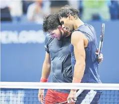  ??  ?? Spain’s Rafael Nadal (right) embraces Austria’s Dominic Thiem after winning their quarterfin­al match. — AFP photo