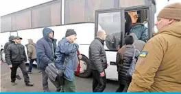  ?? — AFP ?? Pro-Russian rebels - who were made prisoners - board a bus during a prisoner exchange between Ukraine and pro-Russian rebels near the Mayorsk checkpoint yesterday.