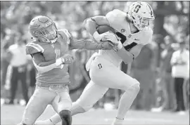  ??  ?? STANFORD TIGHT END Colby Parkinson makes a reception and reaches the UCLA two-yard line against cornerback Darnay Holmes in the second quarter.