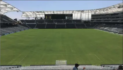  ?? AP PHOTO/GREG BEACHAM ?? In this Thursday, photo workers prepare the playing field at Banc of California Stadium for its official opening today, and the upcoming home debut of Los Angeles Football Club. The MLS expansion team built its $350 million new home in about 18 months,...