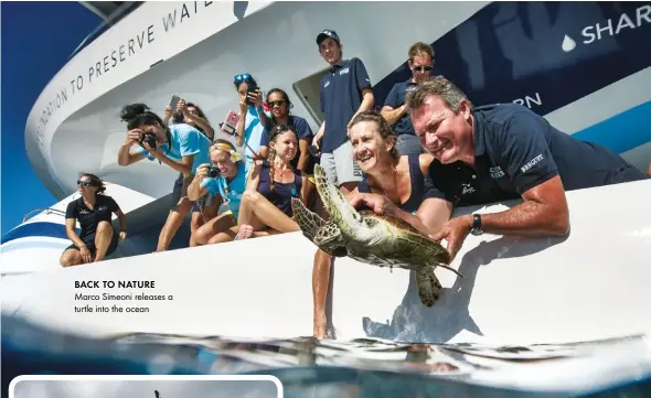  ??  ?? Back to nature Marco Simeoni releases a turtle into the ocean