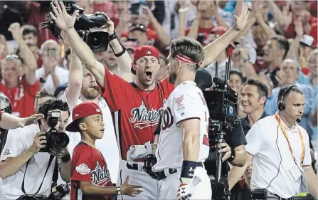 ?? ROB CARR GETTY IMAGES ?? Max Scherzer of the Nationals celebrates with teammate Bryce Harper after Harper’s first-round matchup during the Home Run Derby on Monday.