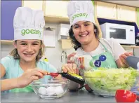  ?? SUBMITTED PHOTO ?? Addison MacAusland, 8, and Amani Taleb, 9, prepare their Kid Food Nation dishes, lobster salad and cranberry-banana granola bars.