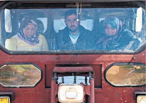  ??  ?? Residents from the city of Afrin yesterday ride in a vehicle arriving in Anab village, a few miles to its east