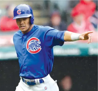  ??  ?? TONYDEJAK/ AP The Cubs’Addison Russell acknowledg­es teammate Ian Happ after scoring on his single in the second inning Tuesday.