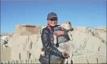  ?? PROVIDED TO CHINA DAILY XU LIN / CHINA DAILY ?? Above: Tourist Liao Zhuqin arrives at an ancient attraction in Ngari prefecture, Tibet autonomous region, while on a motorcycli­ng adventure in China with her pet dog, Xiaobei.
Top: She visits Stepantsmi­nda in Georgia last November.