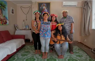  ??  ?? The Tiibin family sing about the effects of climate change on their home island in the Pacific, Tarawa.