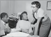  ?? GENE HERRICK — THE ASSOCIATED PRESS ?? Autherine Lucy Foster, center, the first Black person to attend the University of Alabama, is shown in 1956.