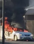  ??  ?? A Ford Falcon sedan engulfed in flames on Silky Oak Lane, Armstrong Creek, on Saturday.