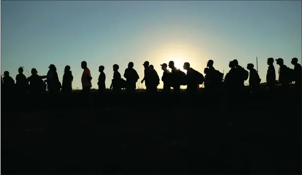  ?? — AP FILE ?? Migrants who crossed the Rio Grande and entered the US from Mexico are lined up for processing by US Customs and Border Protection on September 23, 2023 in Eagle Pass, Texas.