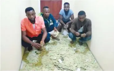  ??  ?? The suspects allegedly arrested with 4,555 stolen national identity cards in Calabar