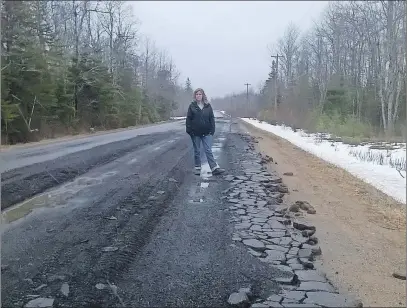  ?? SUBMITTED ?? Jennifer Sawler stands on a heavily damaged section of the North River Road.