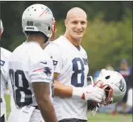  ?? Steven Senne / Associated Press ?? Patriots tight end Rob Gronkowski, right, talks withj teammate Kenny Britt at minicamp practice Tuesday in Foxborough, Mass.