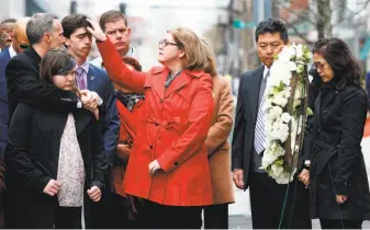  ?? Michael Dwyer / Associated Press ?? The family of Martin Richard — from left: Bill, Jane, Henry and Denise — observes a moment of silence with the father of Lingzi Lu, Jun Lu (second from right) and her aunt Helen Zhao (right) during a ceremony at the site where Martin Richard and Lingzi...