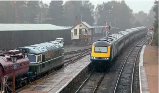  ?? GRAEME ELGAR ?? In preparatio­n for the charity ‘Santa Specials’, on a dreich September 22, Scotrail HST with power cars Nos. 43163 and 43150 arrive at Boat of Garten on the Strathspey Railway with a trial run from Inverness, passing stabled Class 27 No. D5394.