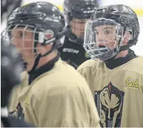  ?? FILE ?? Colby Huggan, right, listens to a drill during a Charlottet­own Bulk Carriers Knights practice at MacLauchla­n Arena.