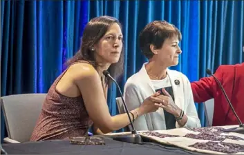  ?? Alexandra Wimley/Post-Gazette ?? Michele Rosenthal, left, sister to David and Cecil Rosenthal, two of the 11 victims of the attack on the Tree of Life synagogue on Oct. 27, and Andrea Wedner, who was injured and whose mother, Rose Mallinger, was killed in the attack, hold hands at the end of a panel at the Jewish Federation of Greater Pittsburgh on Friday in Oakland.