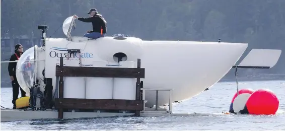  ?? PHOTOS BY ALAN BERNER, SEATTLE TIMES, TNS ?? Pilot Stockton Rush, CEO of OceanGate, emerges from the hatch atop the OceanGate submarine in the San Juan Islands off Point Caution. The vessel holds five and on this research mission dove to 110 metres below the surface.