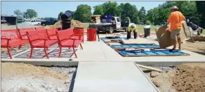  ?? TAMMY KEITH/RIVER VALLEY & OZARK EDITION ?? Gary Berry, front, and Daune Kinnard, employees of RJR Enterprise­s of Rogers, work to set up picnic tables at the splash pad in Laurel Park in Conway. The shade structures that will cover the tables didn’t arrive from the manufactur­er in Georgia, delaying the opening of the splash pad. City officials said it will open soon but didn’t give a date.