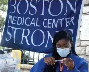  ?? Boston Herald File ?? boston medical center nurse eunide Guillet prepares a dose of coronaviru­s vaccine at a recent event in mattapan.