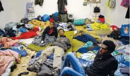  ?? ASSOCIATED PRESS FILE PHOTO ?? Eritrean refugees sit in a shelter in Tel Aviv, Israel. The startling and sudden thaw between longtime enemies Eritrea and Ethiopia is opening up a world of possibilit­ies for the countries’ residents.