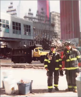  ?? Courtesy Frank Napolitano ?? Greenwich volunteer firefighte­rs Anthony Medico and Sandy Kornberg offer their assistance along with Frank Napolitano (not pictured) at ground zero on Sept. 27, 2001.