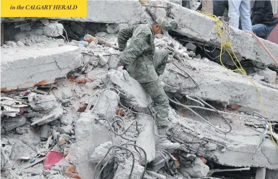  ?? YURI CORTEZ / AFP / GETTY IMAGES ?? Firefighte­rs, policemen, soldiers and volunteers were all part of the search for signs of life in a collapsed building following Tuesday’s earthquake in Mexico City.