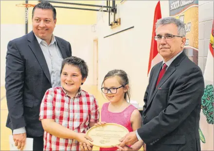  ?? COLIN MACLEAN/JOURNAL PIONEER ?? Queen Elizabeth Elementary School in Kensington received a P.E.I. Environmen­tal Award on Monday. Presenting and accepting the award were, from left, Kensington-Malpeque MLA Matthew MacKay, Grade 3 students Taylor Beamish and PJ Paugh, and Environmen­t Minister Richard Brown.