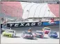  ?? RAY CARLIN — THE ASSOCIATED PRESS ?? A NASCAR official checks drivers as the race was red flagged for over 11 minutes due to an 11-car incident during a NASCAR Cup Series auto race at Texas Motor Speedway in Fort Worth, Texas, Sunday.