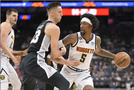  ?? DARREN ABATE — THE ASSOCIATED PRESS ?? The Nuggets’ Kentavious Caldwell-pope, right, drives against the Spurs’ Zach Collins during the first half of their game Friday in San Antonio.