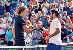  ?? AFP file ?? federer congratula­tes Alexander Zverev after losing 6-3, 6-4 in the 2017 Rogers Cup final. federer is backing Zverev along with a host of other young players to make their mark on the big stage. —