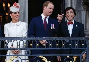  ?? (Yves Herman/Reuters) ?? BRITAIN’S PRINCE WILLIAM (center) and his wife, Kate, appear on a balcony at the Mons Town Hall with Belgian outgoing prime minister Elio Di Rupo in 2014.