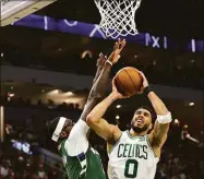  ?? Stacy Revere / Getty Images ?? The Celtics’ Jayson Tatum is defended by the Bucks’ Bobby Portis during the second quarter in Game 6 of the Eastern Conference Semifinals on Friday.