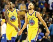  ?? JANE TYSKA — BAY AREA NEWS GROUP, FILE ?? Warriors Stephen Curry (30) and Andre Iguodala (9) celebrate a basket during a 2018 game.