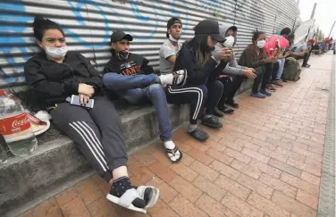  ?? Fernando Vergara / Associated Press ?? Venezuelan migrants wait for buses April 30 in Bogota, Colombia, that will take them to the border.