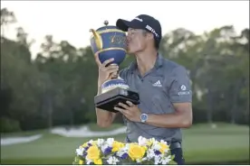  ?? AP photo ?? Collin Morikawa kisses the championsh­ip trophy after winning the Workday Championsh­ip on Sunday.