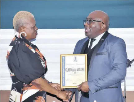  ?? ?? JTA President Leighton Johnson (right) presents a plaque to retiree Claudia Mclean.