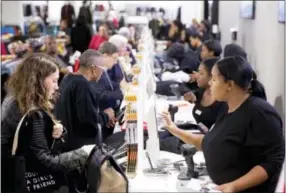  ?? THE ASSOCIATED PRESS ?? Customers check out at a new Century 21Departme­nt Store in Philadelph­ia. The Commerce Department released personal income and spending data for September on Friday.