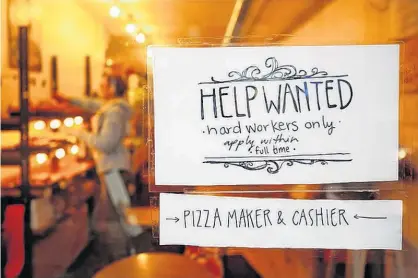  ?? CHRIS WATTIE/REUTERS ?? A “Help wanted” sign is seen in the window of a bakery in Ottawa, Ont., Nov. 2, 2017.