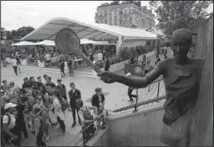  ?? The Associated Press ?? FRENCH OPENING: Children view the statue of late French tennis champion Suzanne Lenglen at the Roland Garros stadium in Paris on Friday. The French Open starts today.