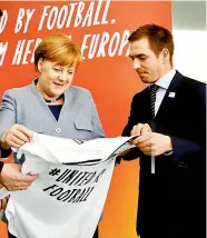  ?? — AP ?? German chancellor Angela Merkel (left) and Philipp Lahm promote the country’s Euro 2024 bid in this file photo.