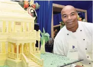  ?? FILE ?? Chef Lincoln Peterkin poses beside his masterpiec­e – a miniature model of Devon House that was done from white chocolate at the JCDC Culinary Festival earlier this year.