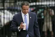  ?? AP PHOTO/SETH WENIG ?? New York Gov. Andrew Cuomo prepares to board a helicopter after announcing his resignatio­n, Tuesday, Aug. 10, 2021, in New York. Cuomo says he will resign over a barrage of sexual harassment allegation­s. The three-term Democratic governor’s decision, which will take effect in two weeks, was announced Tuesday as momentum built in the Legislatur­e to remove him by impeachmen­t.