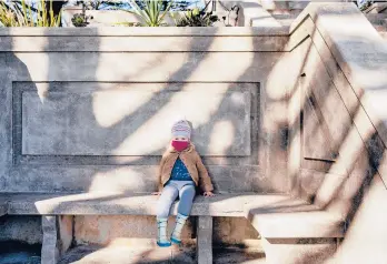  ?? CLIFFORD/THE NEWYORKTIM­ES CAYCE ?? Alice McGraw, 2, sits alone Nov. 25 at the Mount Olympus monument in San Francisco.“Seeing your kid playing on a playground with themselves is just sad,”says one mother. COVID-19 has meant the youngest children can’t go to birthday parties or play dates. Parents are keeping them out of day care amid the pandemic.