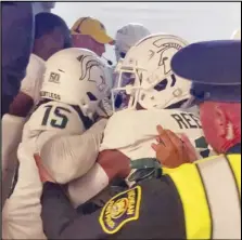  ?? Associated Press ?? Security and police break up a scuffle between players from the Michigan and Michigan State football teams in the Michigan Stadium tunnel after a game on Oct. 29 in Ann Arbor, Mich. Seven Michigan State football players were charged in the postgame melee on Wednesday.