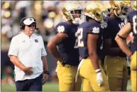  ?? AJ Mast / Associated Press ?? Notre Dame head coach Brian Kelly walks to a huddle during Saturday’s win over Toledo in South Bend, Ind.